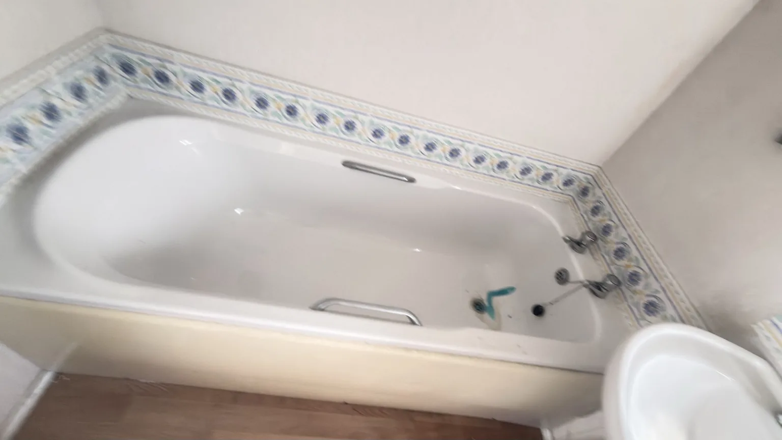 Bathroom bath area before a detailed deep clean