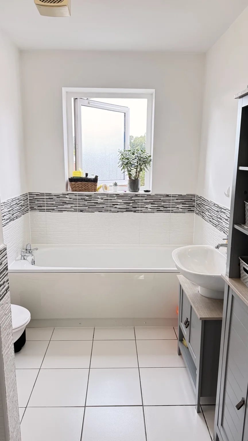 Bright clean bathroom, bath, basin and tiled floor after RASO cleaning
