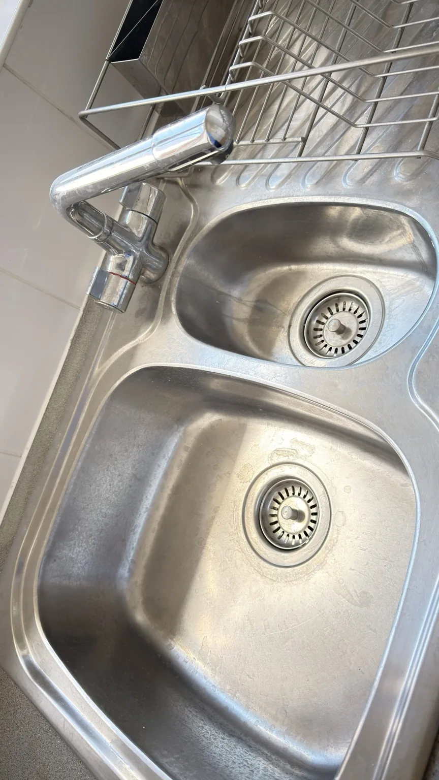 Stainless steel kitchen sink before professional cleaning by RASO Cleaning Service