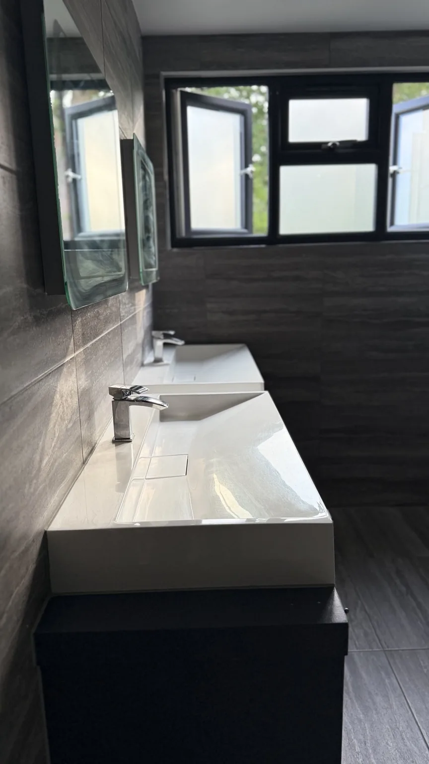 Clean modern bathroom basins and tiled surfaces after RASO cleaning